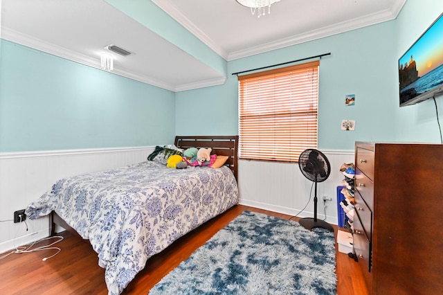 bedroom with dark hardwood / wood-style flooring and crown molding