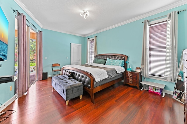 bedroom featuring crown molding, hardwood / wood-style floors, and access to outside