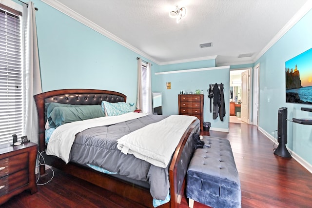 bedroom with crown molding, dark wood-type flooring, and a textured ceiling