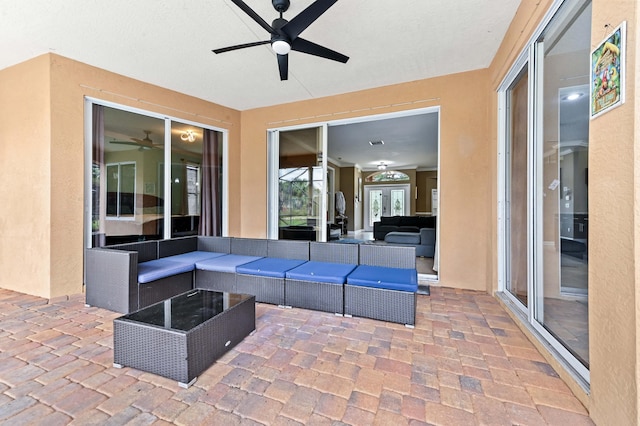 view of patio featuring outdoor lounge area, ceiling fan, and french doors