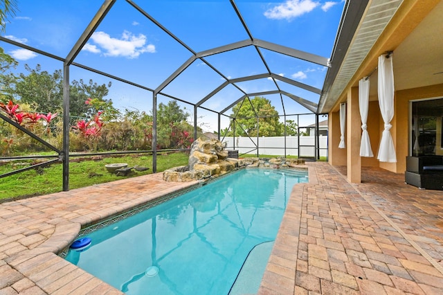 view of pool with a patio and glass enclosure