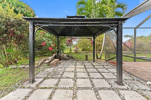 view of patio with a gazebo and glass enclosure