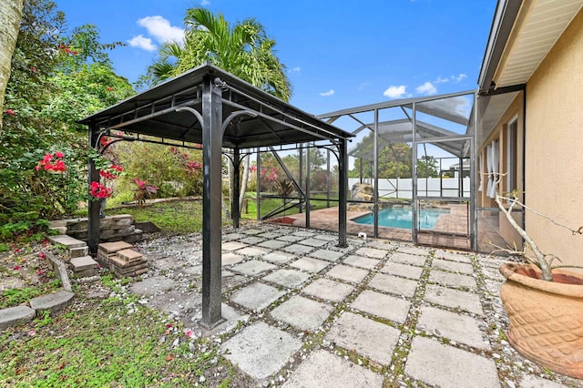 view of patio featuring a fenced in pool and glass enclosure