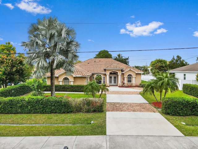 mediterranean / spanish-style home featuring a front yard