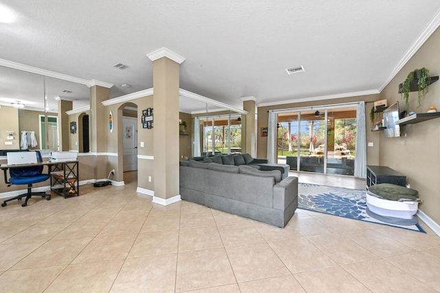 living room with decorative columns, crown molding, and light tile patterned floors