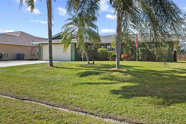 view of front of house featuring a garage, a front lawn, and central air condition unit