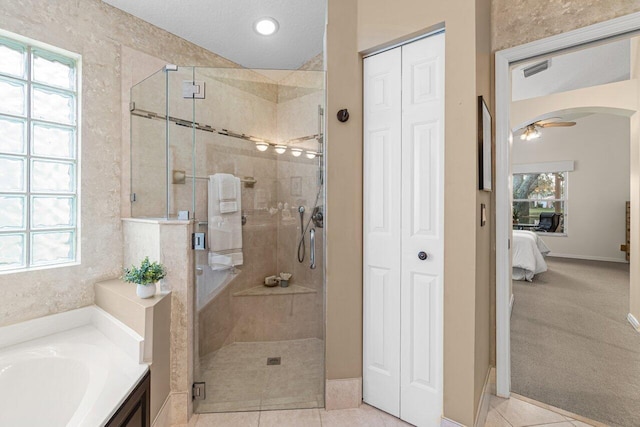 bathroom featuring shower with separate bathtub and tile patterned floors