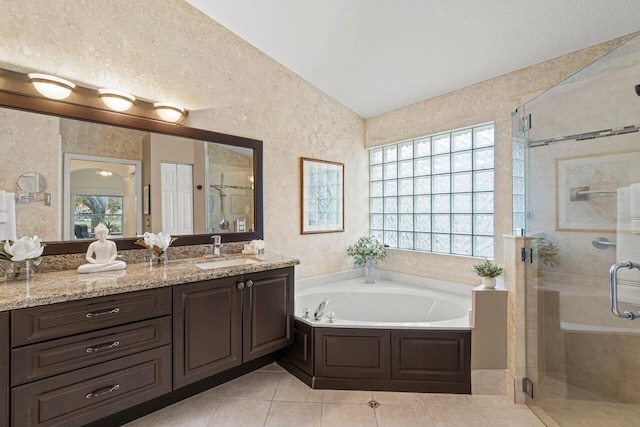 bathroom featuring vanity, tile patterned floors, independent shower and bath, and a textured ceiling