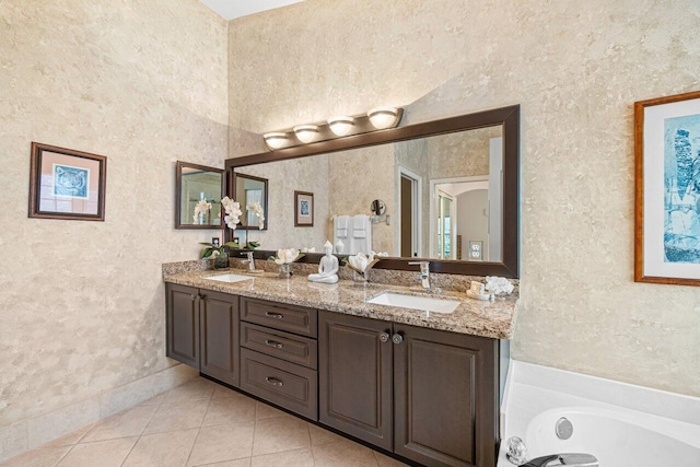 bathroom featuring vanity, tile patterned floors, and a bathing tub