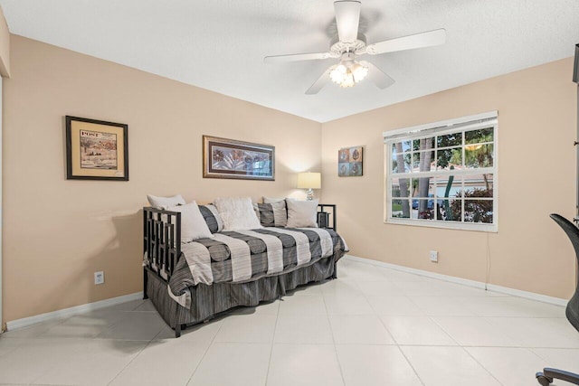 tiled bedroom with a textured ceiling and ceiling fan