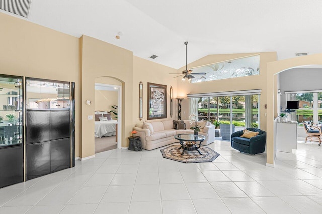 tiled living room with high vaulted ceiling and ceiling fan