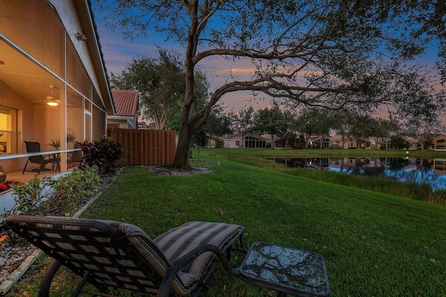 yard at dusk with a water view