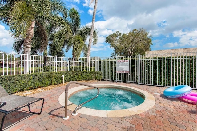 view of swimming pool featuring a community hot tub