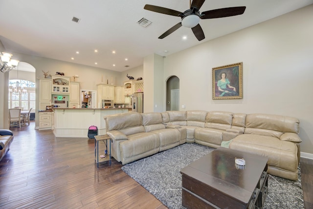 living room with dark hardwood / wood-style floors and ceiling fan with notable chandelier