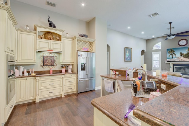 kitchen with high end fridge, sink, dark hardwood / wood-style flooring, dishwashing machine, and cream cabinets