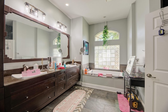 bathroom with vanity and a tub