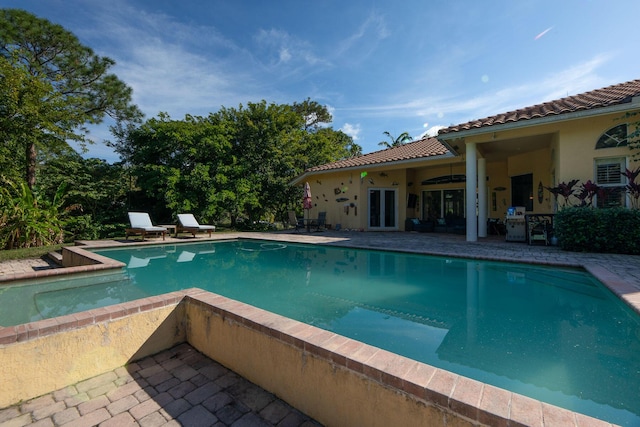 view of swimming pool featuring a patio area