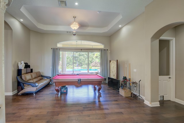 rec room with a tray ceiling, billiards, dark hardwood / wood-style floors, and a high ceiling