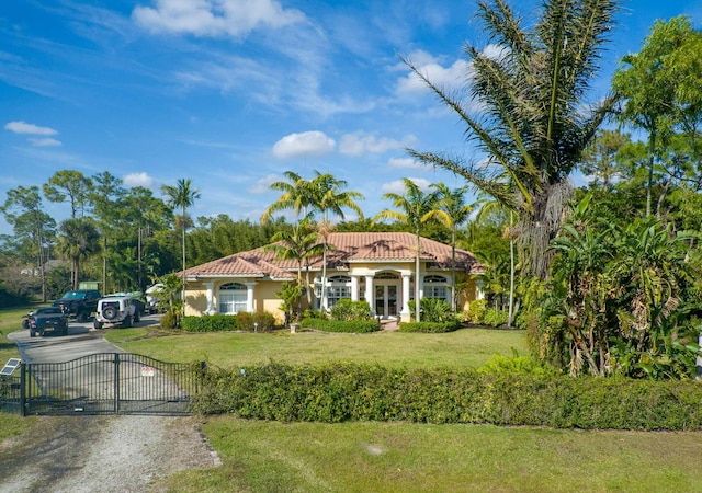 mediterranean / spanish house featuring a front yard