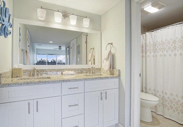 bathroom featuring toilet, vanity, a shower with shower curtain, ceiling fan, and tile patterned flooring