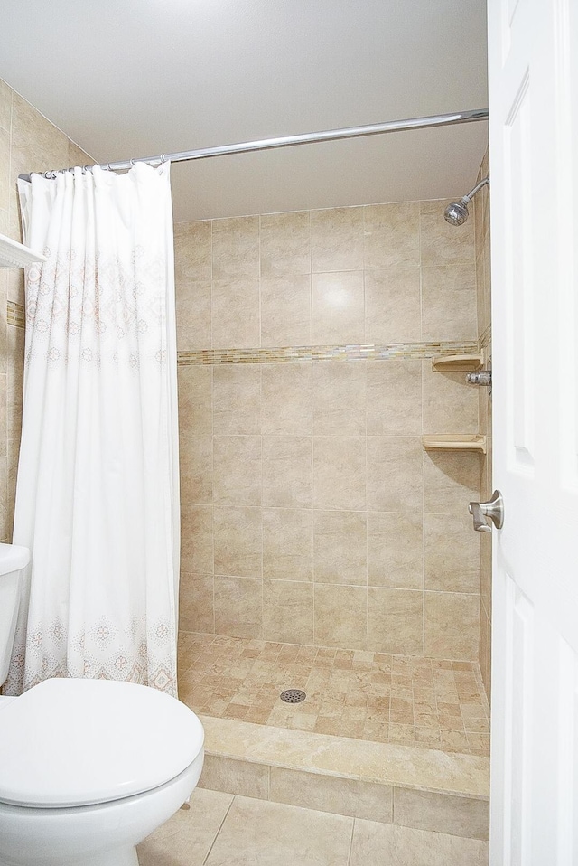 bathroom with a shower with curtain and toilet