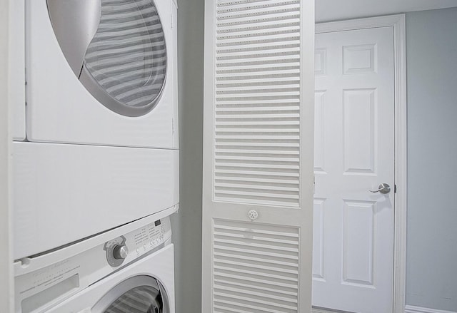 clothes washing area with stacked washer and dryer