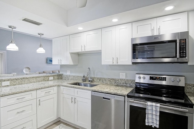 kitchen featuring white cabinetry, sink, and appliances with stainless steel finishes