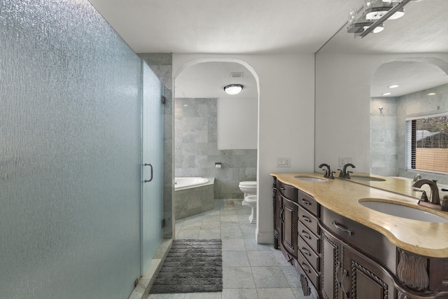 full bathroom featuring a bidet, tile patterned flooring, vanity, shower with separate bathtub, and toilet