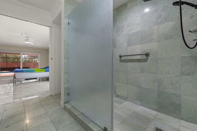 bathroom featuring crown molding, tiled shower, and tile patterned floors