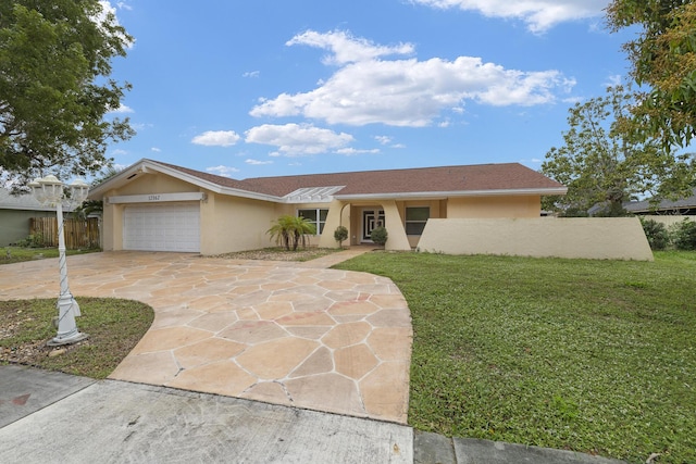 single story home featuring a garage and a front yard