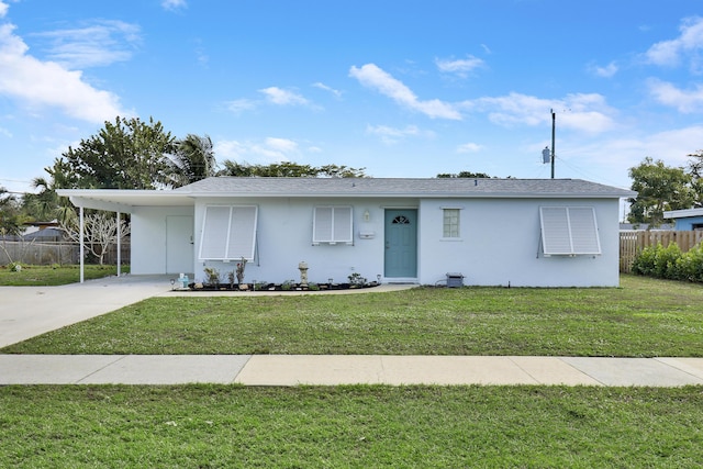 ranch-style house with a carport and a front lawn