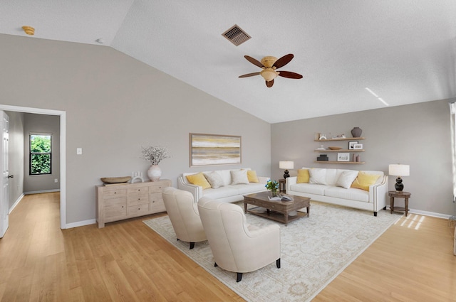 3215 NW 12th St, Delray Beach, FL 33445 - living room with vaulted ceiling, a ceiling fan, light wood-style floors, baseboards, and a textured ceiling