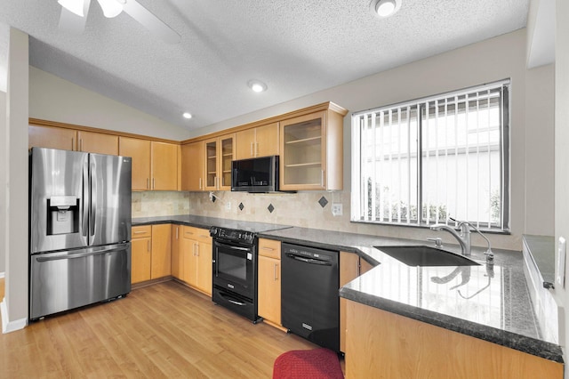 3215 NW 12th St, Delray Beach, FL 33445 - kitchen with black appliances, a sink, tasteful backsplash, a textured ceiling, and light wood-type flooring