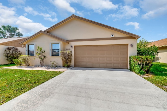 single story home with a garage and a front lawn