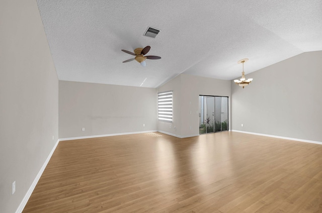 3215 NW 12th St, Delray Beach, FL 33445 - unfurnished living room with vaulted ceiling, ceiling fan, a chandelier, baseboards, and a textured ceiling