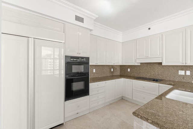 kitchen featuring sink, backsplash, white cabinetry, crown molding, and black appliances