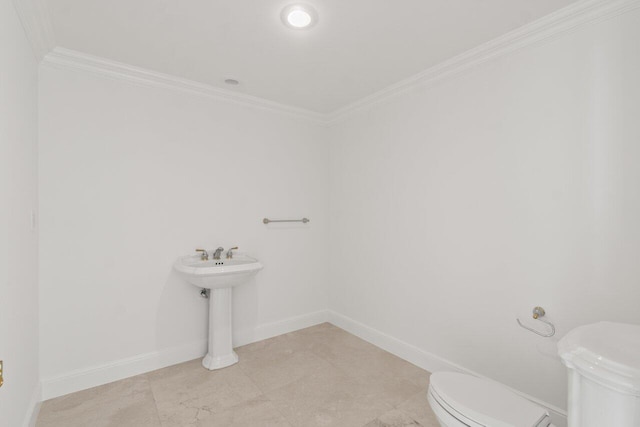 bathroom featuring ornamental molding and toilet