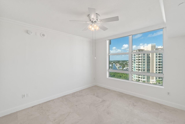 empty room with ornamental molding and ceiling fan