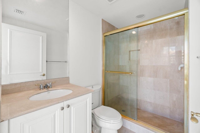 bathroom featuring vanity, toilet, and walk in shower