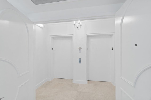 interior space with elevator and a chandelier