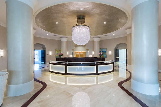 reception with a notable chandelier and ornate columns