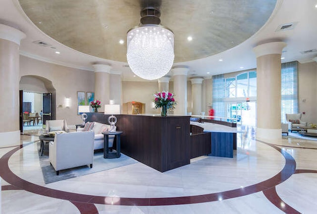 reception with ornate columns and a notable chandelier