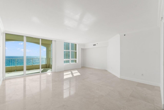 spare room with a wall of windows, a water view, and crown molding