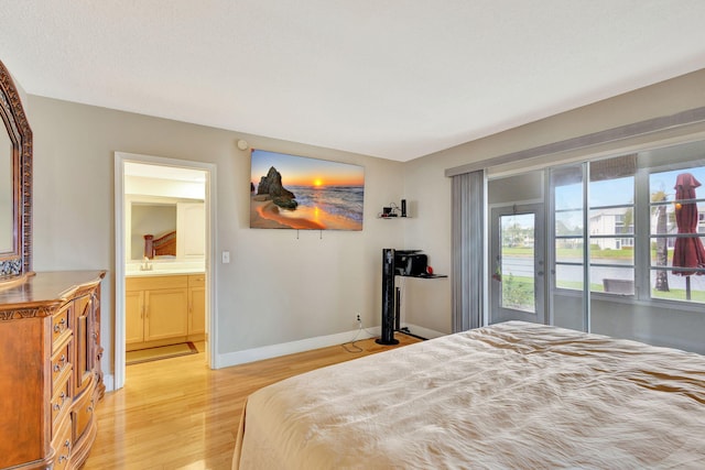 bedroom featuring ensuite bathroom, access to exterior, and light hardwood / wood-style flooring