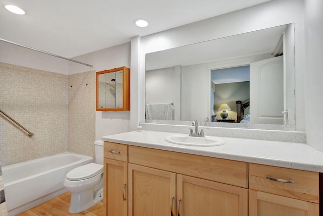 full bathroom with vanity, toilet, tiled shower / bath combo, and wood-type flooring