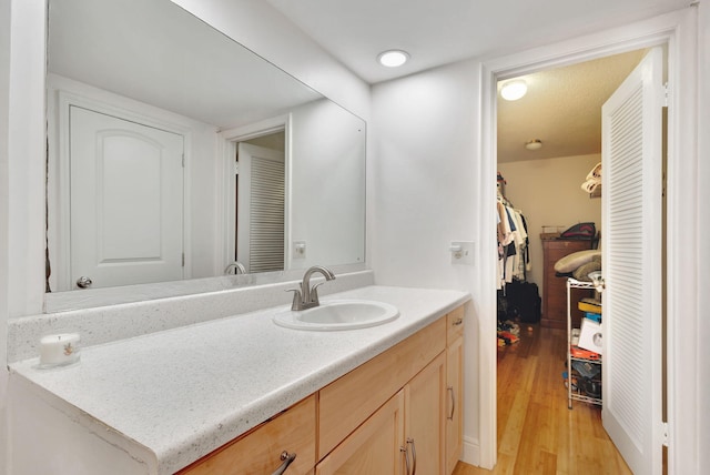 bathroom with vanity and hardwood / wood-style flooring