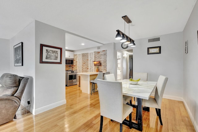 dining space with light wood-type flooring