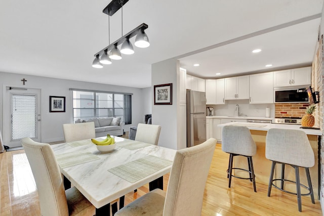 dining area featuring light hardwood / wood-style floors and sink