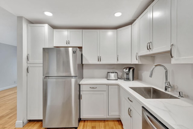 kitchen with sink, stainless steel appliances, and white cabinets