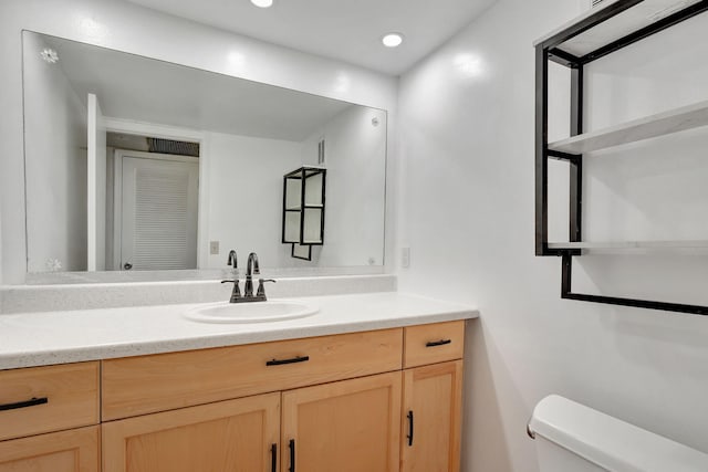 bathroom featuring vanity and toilet